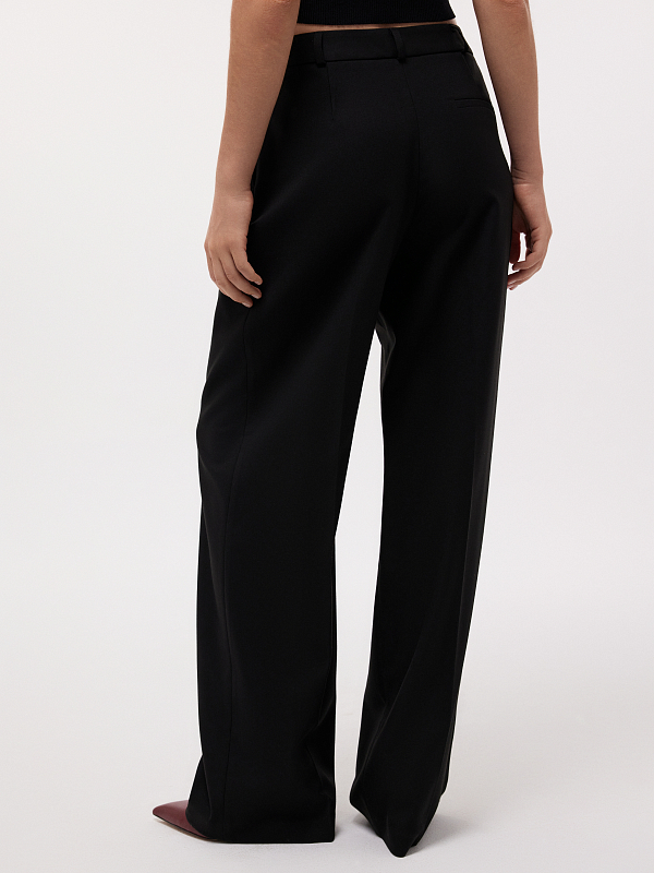 Удлиненные брюки с защипами