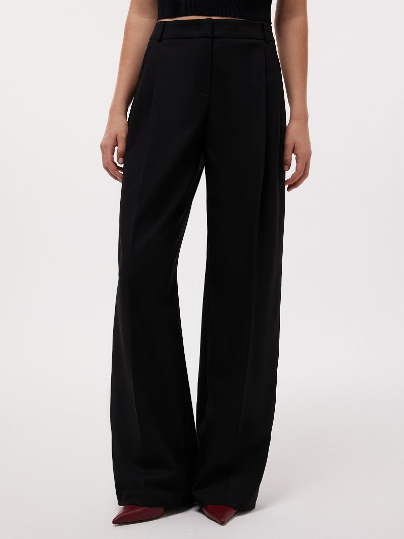 Удлиненные брюки с защипами